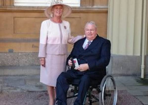 David Walker, of Alfreton-based Autochair, was accompanied by wife Carol when he recived his OBE from the Queen for services to the disabled.