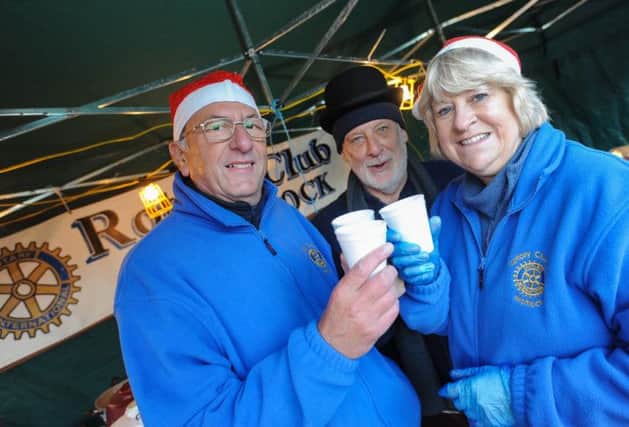 Matlock Victorian Christmas market. Pictured is Julian, Terry and Cynthia from Matlock Rotary Club selling mulled wine.