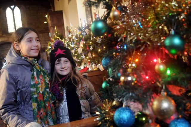 All Saints Church Christmas tree festival, Bakewell.
Sarah and Constance Jandos take a look at the Crafty Kids Club tree during a holiday from France.