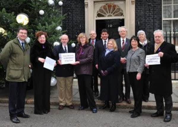 Pictured is Pauline Latham OBE, Member of Parliament for Mid Derbyshire, delivering a petition to 10 Downing Street, alongside Pancreatic Cancer UK, and patients and families who have been affected by the disease.
