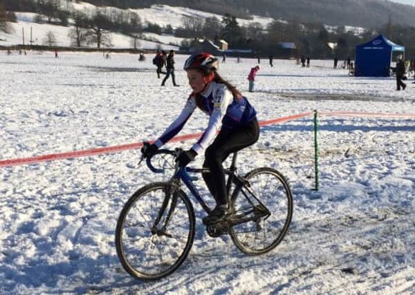 Libby Smith in action at Bakewell. Below, Arthur Green battles in the snow.