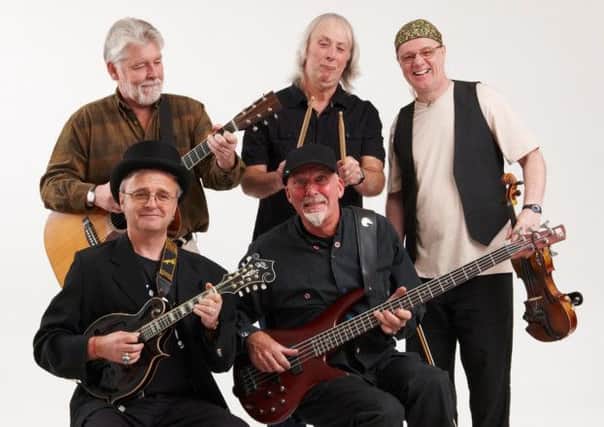 Fairport Convention photographed in 2011. Standing (left to right) Simon Nicol, Gerry Conway, Ric Sanders: seated (left to right) Chris Leslie, Dave Pegg. Photo by Ben Nicholson.