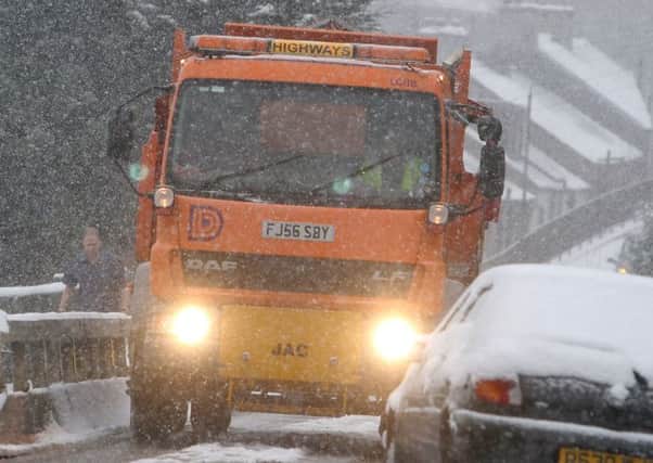 Snow pics, Buxton, a gritter reverses between parked cars in Fairfield