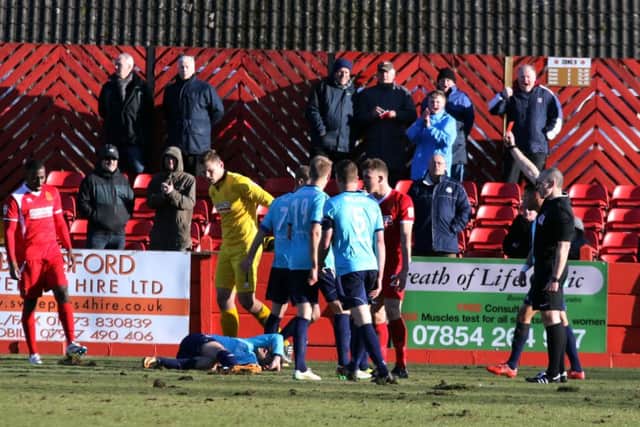 Alfretons Niall sees red after felling an Aldershot player in the box.
