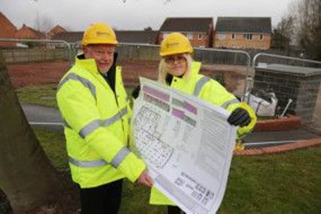 Building for the future: Derbyshire County Councilâ¬"s Cabinet Member for Health and Communities Councillor Dave Allen checks out the plans for Heanorâ¬"s new library on site with senior libraries manager Julie Stirland.
