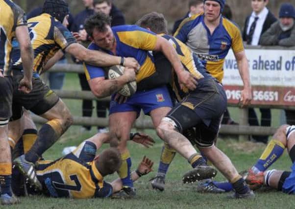 James Cooper is tackled when in possession. Photo by Colin Baker.