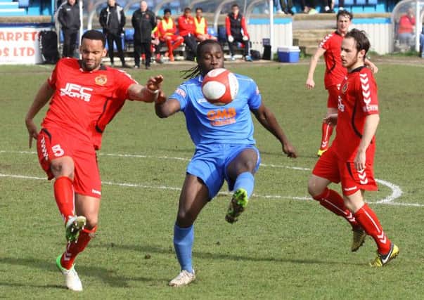 Julian Banton (centre) is pictured in possession during the loss to Curzon Ashton on Saturday.