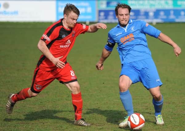 Danny Holland (right) is pictured on the ball during the 0-0 draw with Buxton on Easter Monday