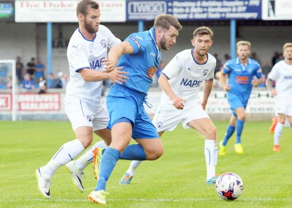 Micky Harcourt of Matlock shields the ball from Jimmy Ryan and Jay OShay of Chesterfield in the pre-season battle last summer. The sides will meet again on July 14th.