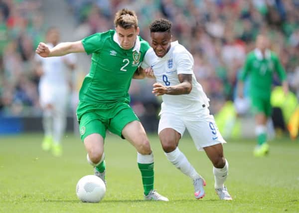 England's Raheem Sterling (right) and Republic of Ireland's Seamus Coleman battle for the ball.