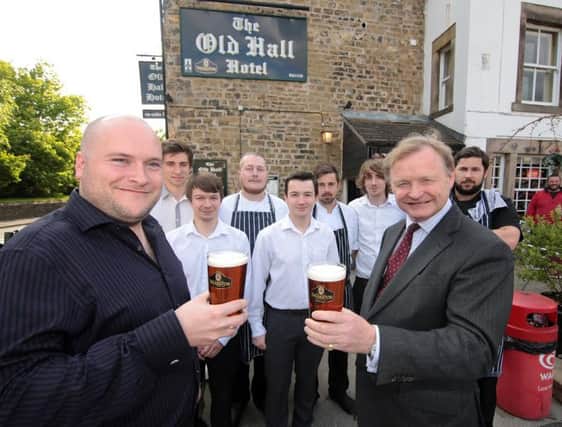 Landlord Rick Ellison with staff and Simon Theakston, managing director of family brewer T&R Theakston Ltd. Picture by Glenn Ashley.