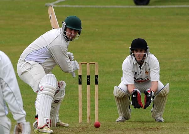 Duffield's Peter Jenkins looks to play a shot with Alfreton's wicket keeper Mark Stokes waiting for a mistake. Picture: Andrew Roe