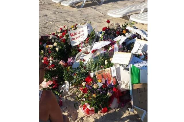 The couple joined others in leaving a flower tribute at the site on Monday (June 29).