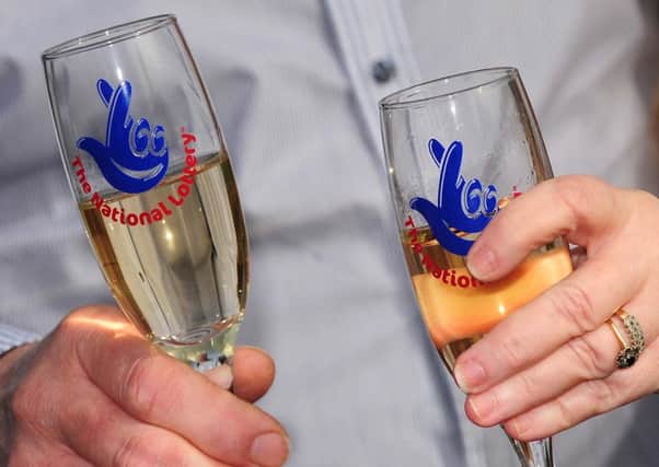 File photo dated 28/02/13 of National Lottery champagne flutes as the Lottery will mark two decades of creating millionaires and supporting good causes when it whirs up its draw machine and brightly coloured balls tomorrow. PRESS ASSOCIATION Photo. Issue date: Tuesday November 18, 2014. More than £30 billion has been raised for charity since the first draw, on November 19 1994, while in excess of 3,700 ticket-holders have been made into millionaires during its 20-year history. Organisers say prize money of more than £53 billion has been handed out - an average of £33 million each week. See PA story LOTTERY Anniversary. Photo credit should read: Rui Vieira/PA Wire