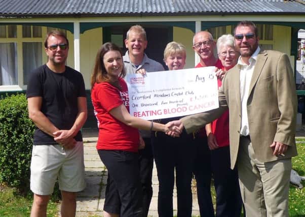 Members of the Cromford Cricket Club present a cheque to the Leukaemia & Lymphoma Research charity following the successful charity cricket match.