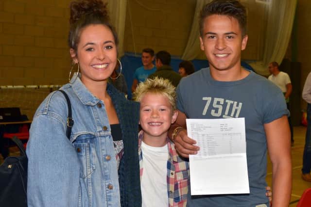 Highfield School A level - Zach Gaiqui celebrates with his sister Olivia and brother Jasper