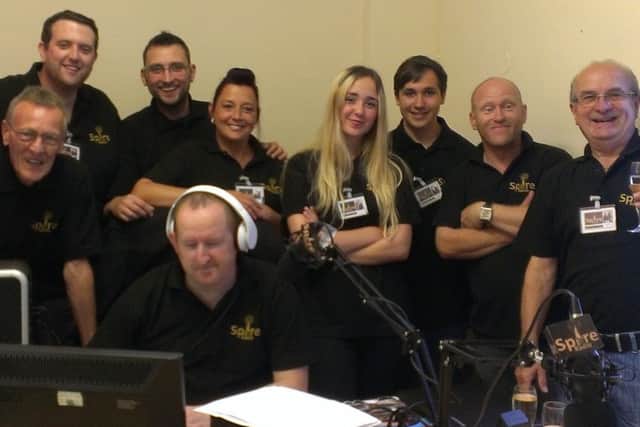 Geoff Cox, managing director (far right) with Paul Wragsdale at the desk and members of the Spire Radio team.