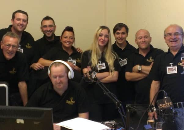 Geoff Cox, managing director (far right) with Paul Wragsdale at the desk and members of the Spire Radio team.
