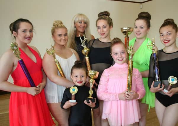 .Nichola Buckley (back centre) shares a proud moment with her dancing stars who took on the world.

Photo by Peter Jordan