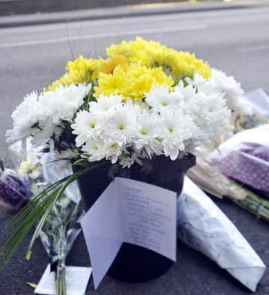 Tributes have been left at the side of the road.