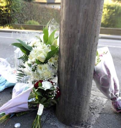 Tributes have been left at the side of the road.