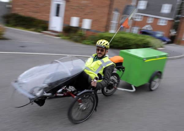Revd Adam Wells from Wesley Methodist Church uses a trike to get around all the churches in Mid Derbyshire and he uses a trailer so he can carry his guitar and amp