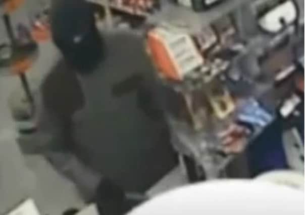 A masked Jamie Lakin, with a knife in his right hand, strikes at One Stop, Mansfield Woodhouse. He has now been jailed for 17 years after admitting a string of robberies.
