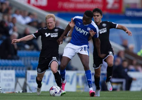 BATTLING HIS WAY TO THE TOP -- Gboly Ariyibi in action for Chesterfield against Wigan Athletic this season.