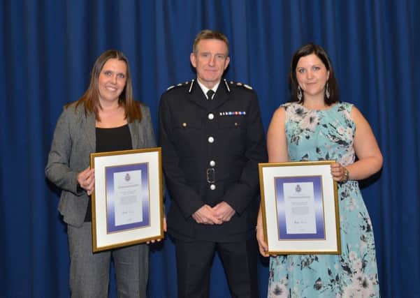 Detective Constables Sarah Adams and Sarah Fraser receive their awards from Chief Constable Mick Creedon.