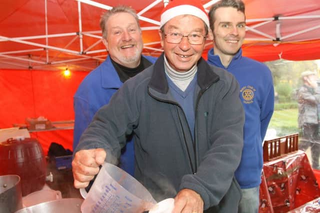 Matlock Christmas markets, mulling the wine rotarians Paul Edwards, Roger Hardy and president Peter Kidd