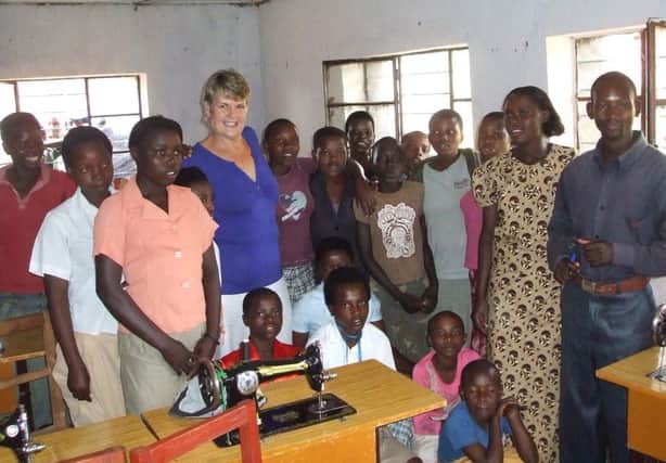 Charity founder Heather Thomas with some of the people the charity helps in Rwanda.