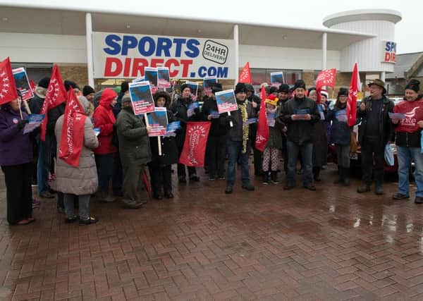 Campaigners sing a hymn about exploitation outside Sport Direct store in Mansfield