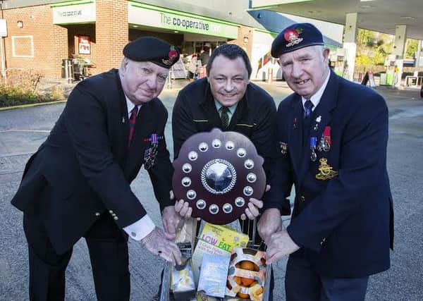 Wirksworth Foodstore manager Adrian Dent  receivies a plaque for the stores commitments and support to the Royal British Legion over the Remembrance Sunday weekend. Pictured with Adrian are Michael Harris ( Vice-Chairman RBL Wirksworth) and David Champion (RBL Committee member)