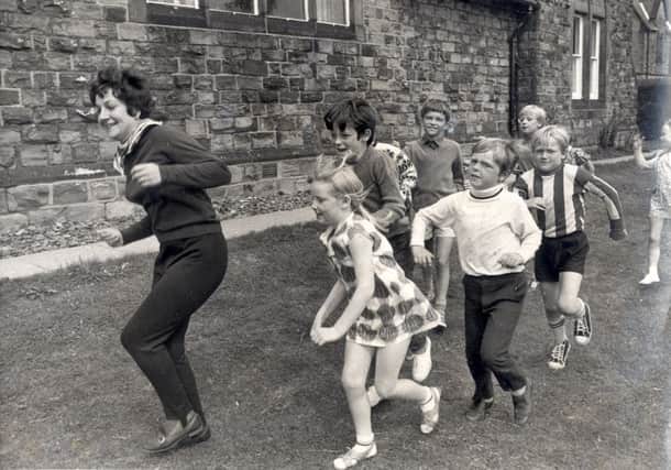 Mrs Margaret Andrews leads a game of "follow my leader" at the Eagle Youth club, Newbold ,Chesterfield during a play scheme...Aug 9th 1971