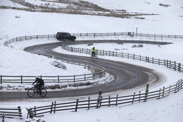 Cyclists make their way up to Mam Tor after overnight snowfall near Edale in the Derbyshire Peak District. All Rights Reserved: F Stop Press Ltd. +44(0)1335 418365   +44 (0)7765 242650 www.fstoppress.com