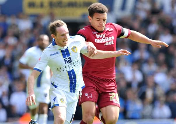 Aidan White and Mason Bennett challenge for the ball.
Leeds United v Derby County.  SkyBet Championship.  3 May 2014.  Picture Bruce Rollinson