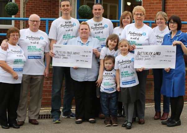 Mark and Dean Smith with their family supporters hand over the proceeds of their fiund raising efforts to Ripley Hospital and Macmillan Cancer Support