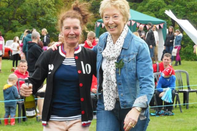 Current member Jan Forrester (left) is presented with a prize by former Olympic athlete Ann Packer in 2015.