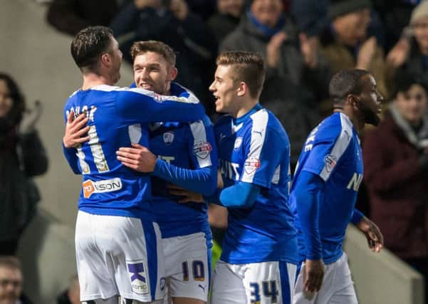 Chesterfield vs Blackpool - Jay O'Shea is congratulated on his goal by Lee Novak and Declan John - Pic By James Williamson