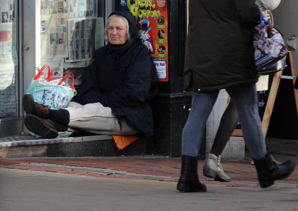 A homeless person in a shop front.