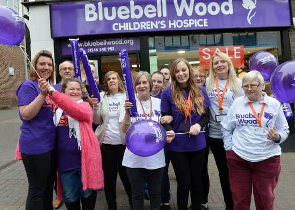 Chesterfield Bluebell wood charity shop anniversary. Staff ans volunteers celebrate outside the shop.