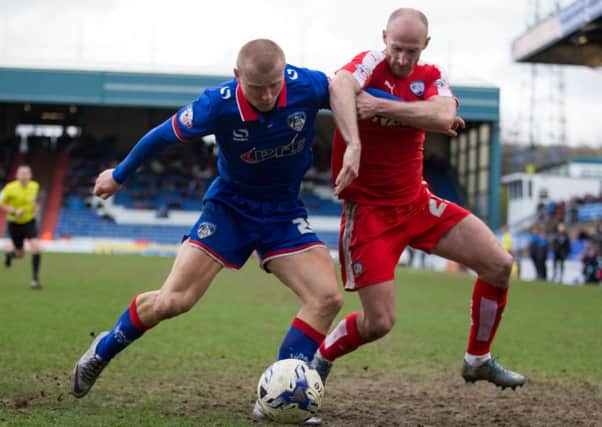 Oldham vs Chesterfield - Drew Talbot battles for the ball - Pic By James Williamson