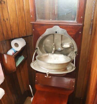 The restored toilet and fold down wash basin in the carriage