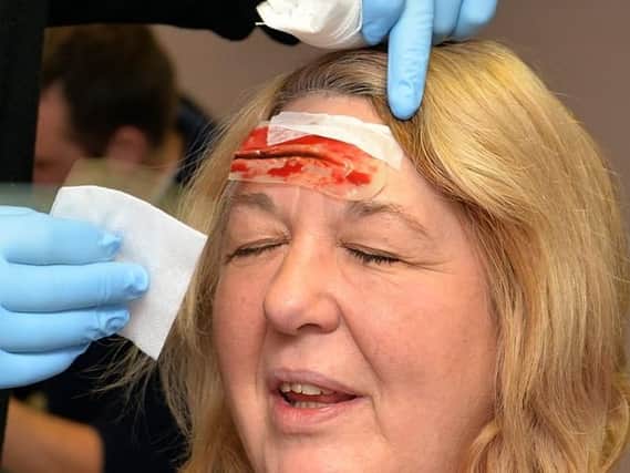 Is it an emergency? EMAS warns that pressure from unnecessary call-outs is burdening the service. (Picture: A first-aider dresses a false cut as part of St John's Ambulance training).