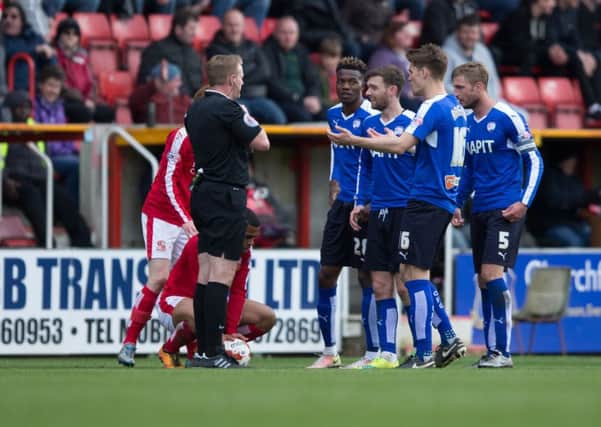Swindon Town vs Chesterfield - Chesterfield players surround referee Trevor Kettle after sending off Charlie Raglan for a second bookable offence - Pic By James Williamson