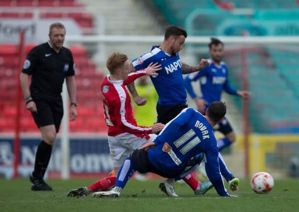 Swindon Town vs Chesterfield - Lee Novak injures himself going for this challenge - Pic By James Williamson