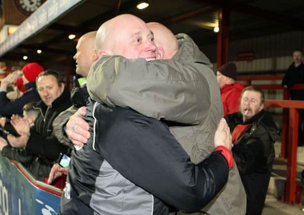 Fans hug manager Nicky Law after winning the Derbyshire FA Senior Cup  - Pic by: Richard Parkes