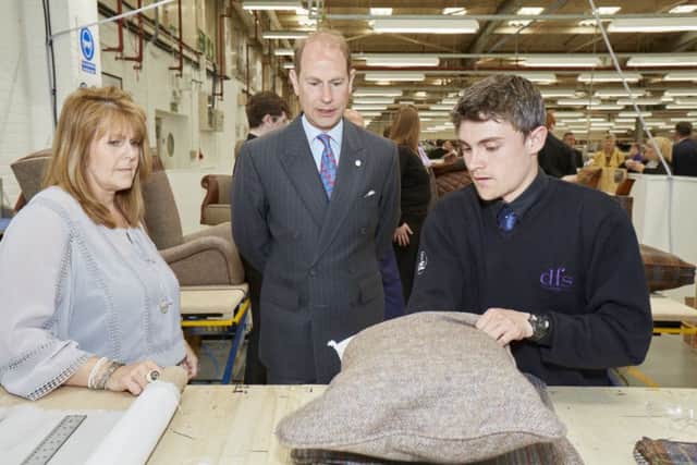 DFS Training Manager Rachel Bamford and DFS apprentice Cameron Smith demonstrating cushion stuffing.
