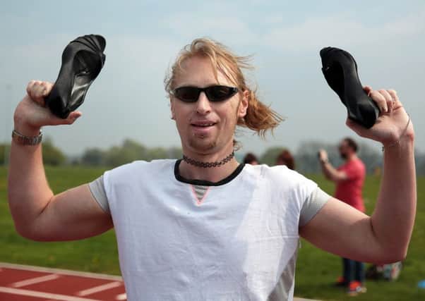 Marty Powell sets a new world record for the Mens 100m in high heels at Tupton Hall School, Chesterfield.
