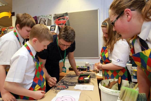 Steve is pictured working with the pupils.